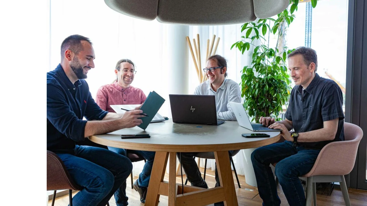 Team members Oliver Berndt, Wolfgang Ziegler, Jeremy Chinquist and Marko Cvetkovic at a meeting table.