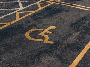 © Photographer: Jakub Pabis
Source: Unsplash A handicap parking space with a yellow wheelchair symbol