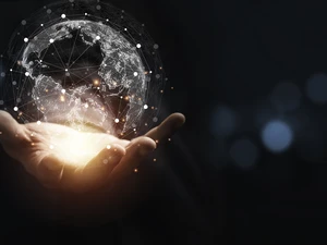 Hand holding a glowing virtual globe with network connections